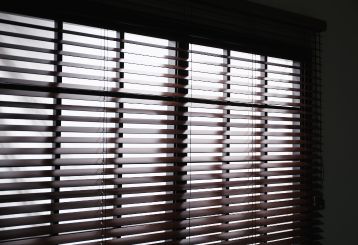 Faux wood blinds installed on windows in a cozy living room.