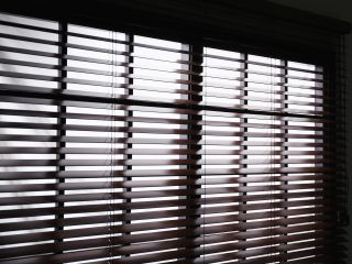 Faux wood blinds installed on windows in a cozy living room.